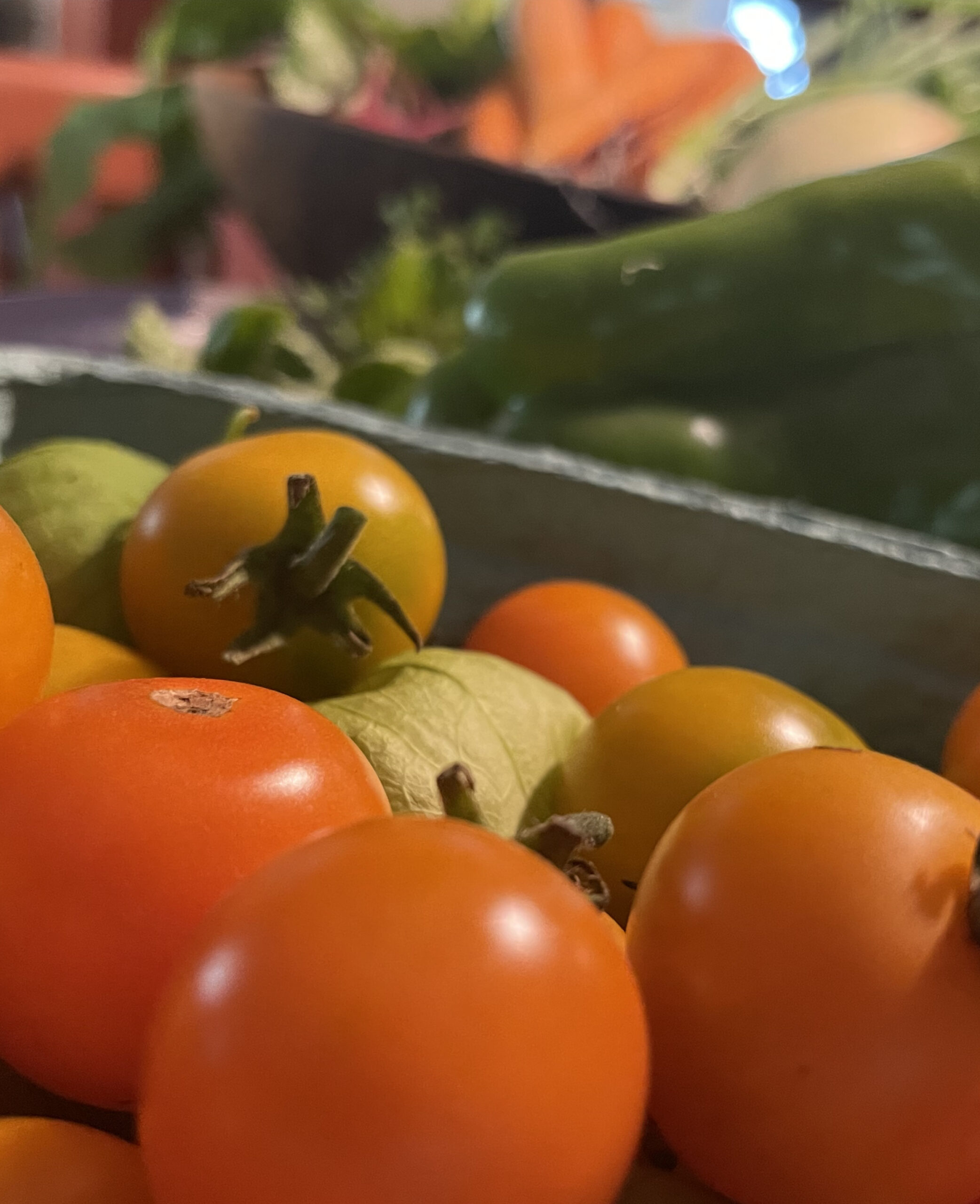 Cherry tomatoes and local farm vegetables catch the light. Photo by Kate Abbott