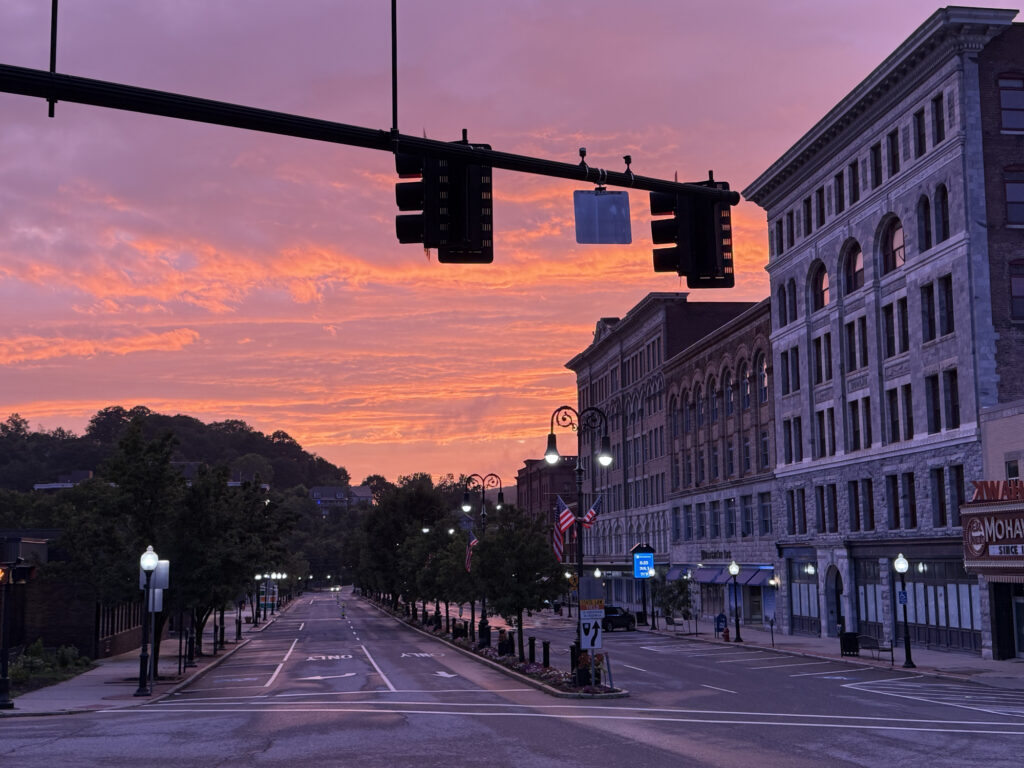 Sunset light paints the sky in North Adams in vivid pink and orange.