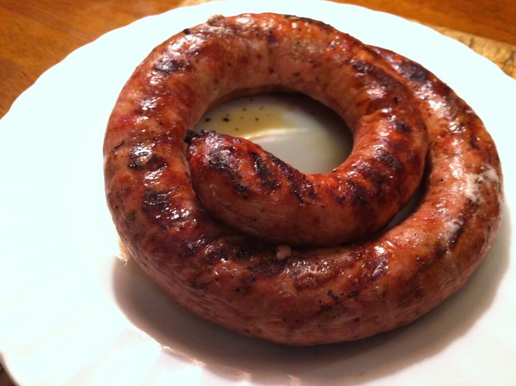 Spicy salami from Fortuna’s Sausage curls on a white china plate. Press photo courtesy of Patt Fortuna