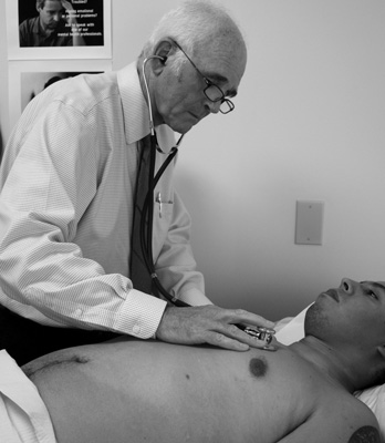 Dr. Jeffrey Blake examines a patient. Tricia Bevin photo