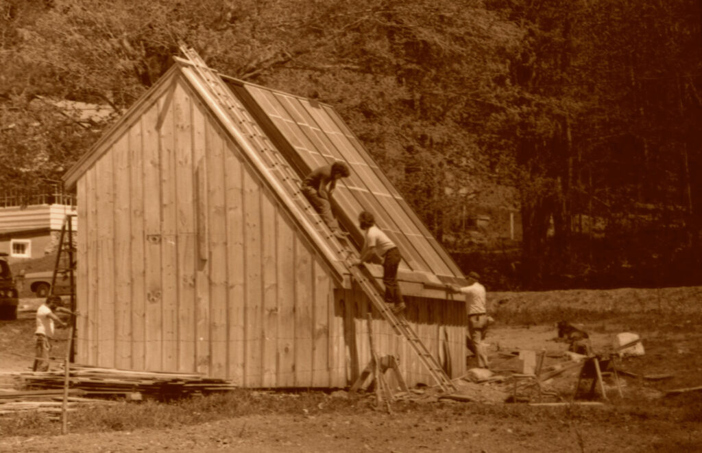 Students install solar panels at the Center for Resourceful Living. Press photo courtesy of the Archives of Freel Library, Massachusetts College of Liberal Arts