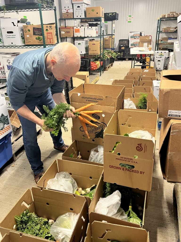 Volunteers for Berkshire Bounty pack boxes to deliver to meal sites and food pantries. Press photo courtesy of Berkshire Bounty